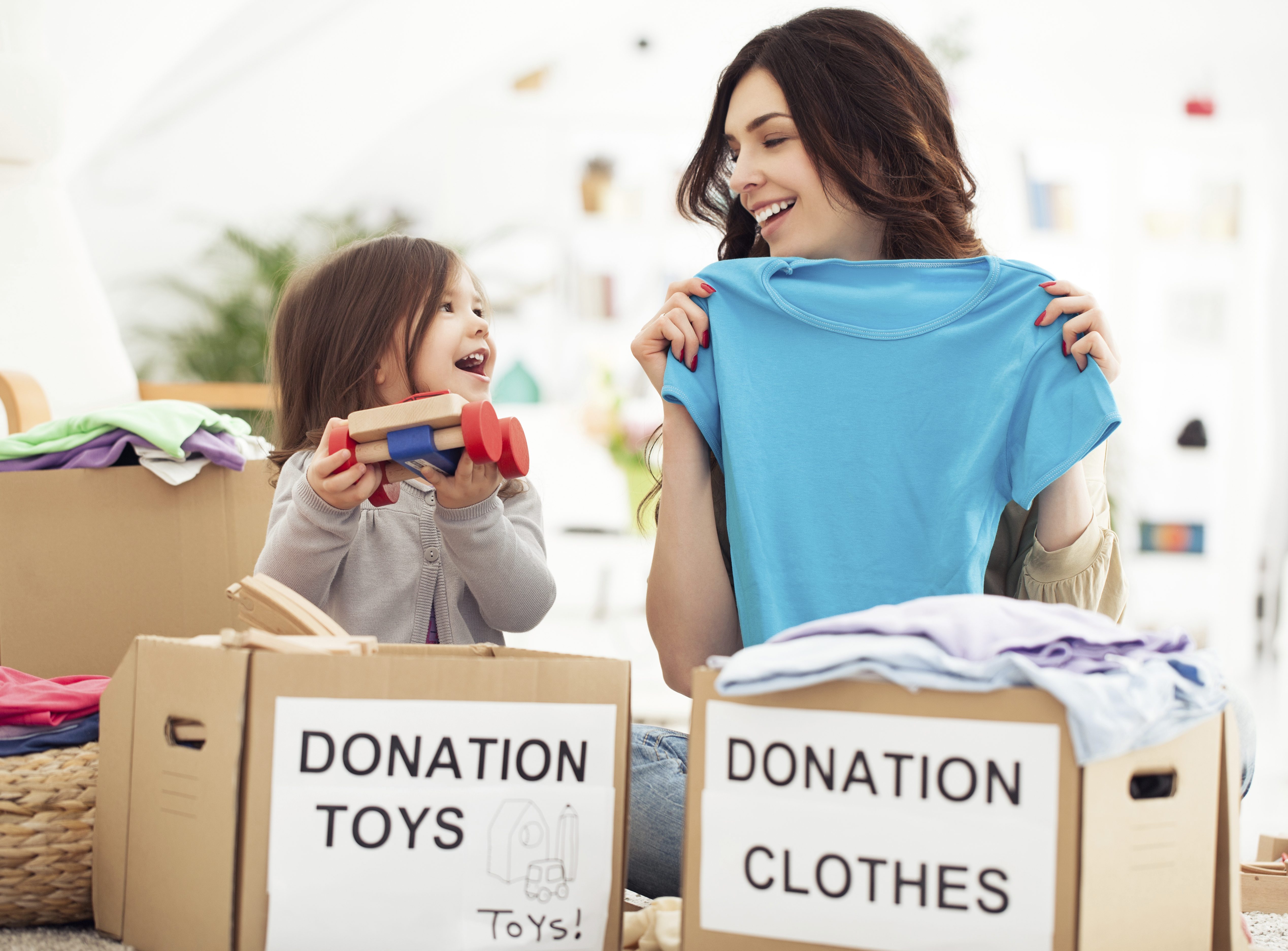mom and daughter donating clothes