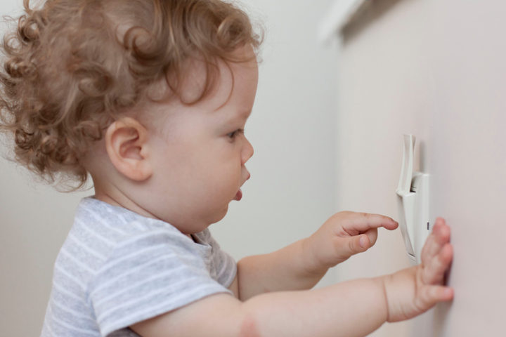 little boy with plug. child at risk of electric shock