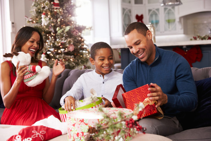 Family Opening Christmas Presents At Home Together